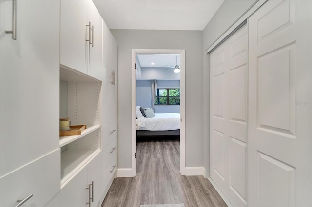 corridor with light hardwood / wood-style floors