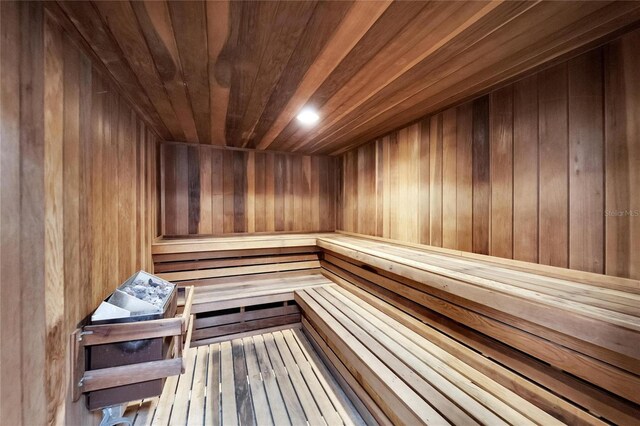 view of sauna with wooden ceiling, hardwood / wood-style flooring, and wood walls