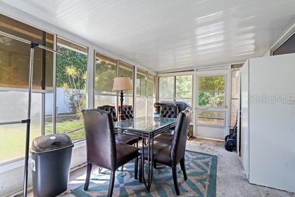 sunroom with lofted ceiling and plenty of natural light