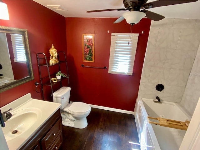 full bathroom with a healthy amount of sunlight, toilet, hardwood / wood-style flooring, and ceiling fan