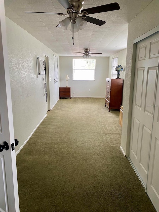 unfurnished bedroom featuring ceiling fan and carpet floors