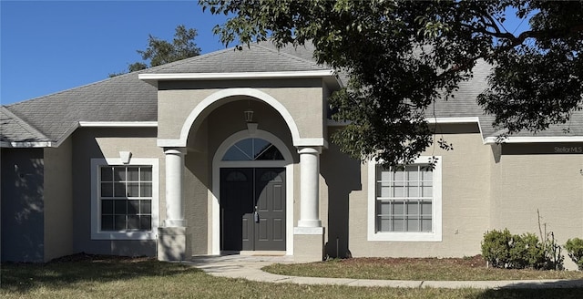 property entrance with a yard