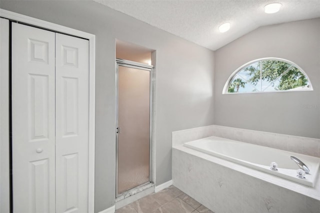 bathroom featuring a textured ceiling, vaulted ceiling, and plus walk in shower