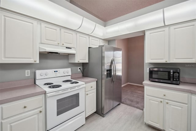 kitchen with appliances with stainless steel finishes, white cabinets, and a textured ceiling