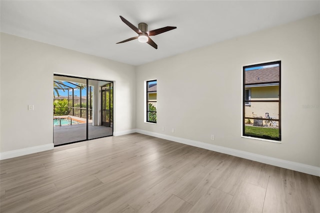 empty room featuring ceiling fan and light hardwood / wood-style floors