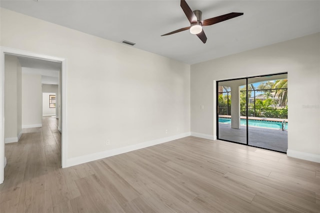 empty room featuring ceiling fan and light hardwood / wood-style floors