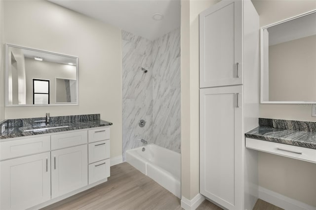 bathroom with vanity, tiled shower / bath combo, and hardwood / wood-style floors