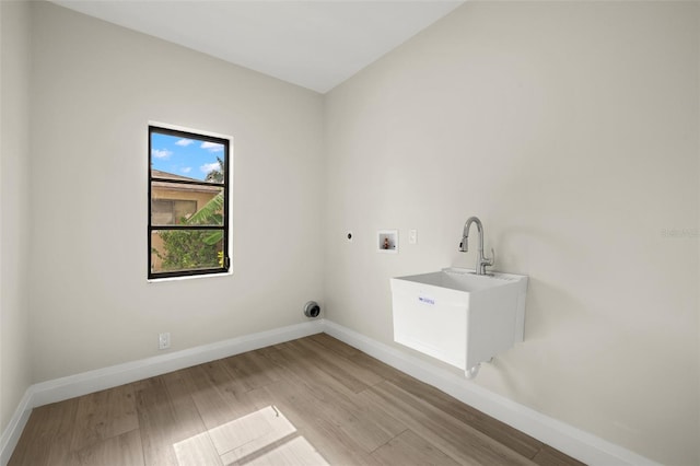 washroom featuring light wood-type flooring, washer hookup, and hookup for an electric dryer