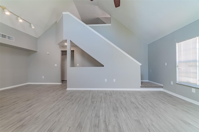 unfurnished living room with a ceiling fan, baseboards, visible vents, and wood finished floors