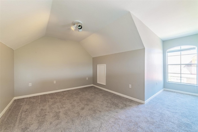 bonus room with carpet, vaulted ceiling, and baseboards