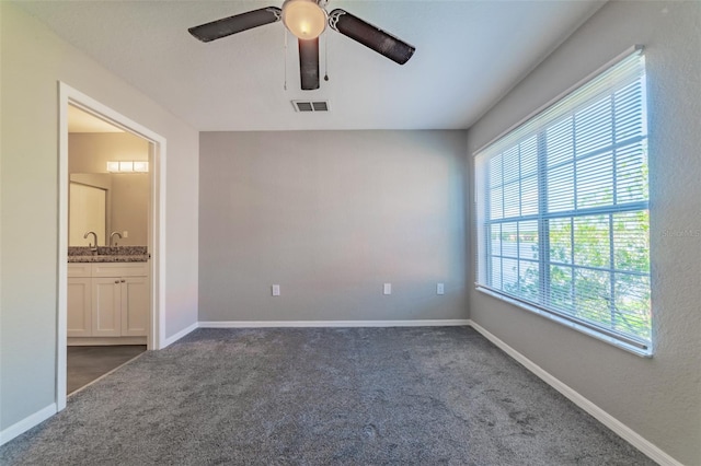 interior space with ceiling fan, plenty of natural light, and carpet