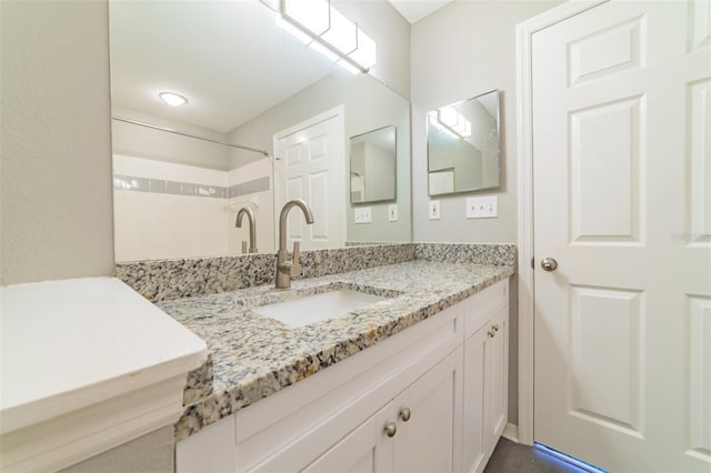 bathroom with vanity and walk in shower