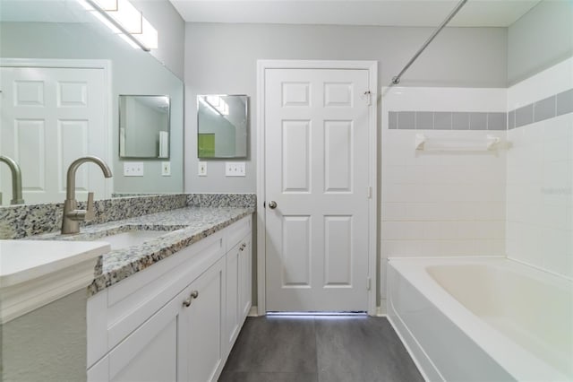 bathroom with shower / washtub combination, wood finished floors, and vanity