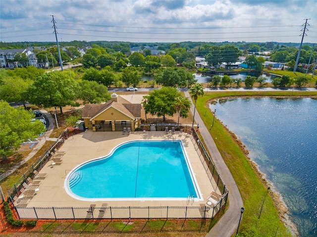 view of swimming pool featuring a water view and a patio area