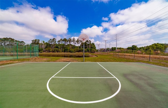 view of basketball court with community basketball court and fence