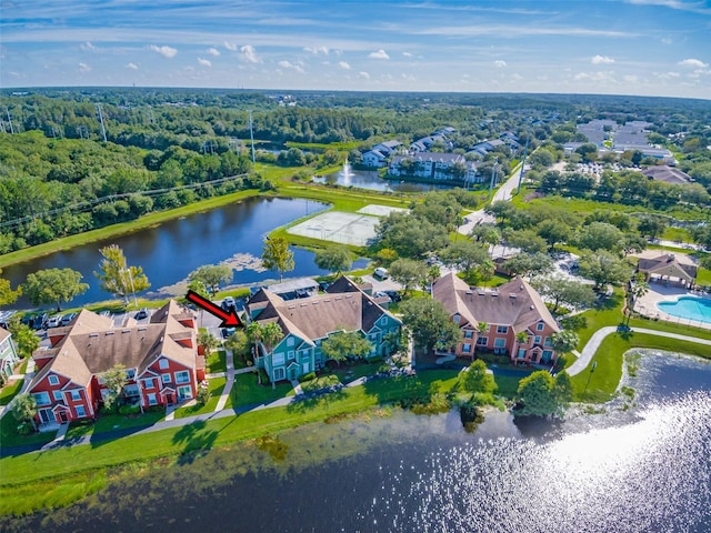 birds eye view of property with a forest view, a water view, and a residential view