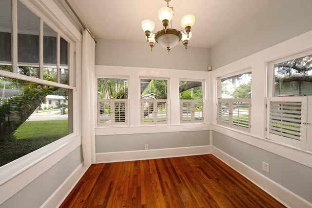 unfurnished sunroom featuring a chandelier