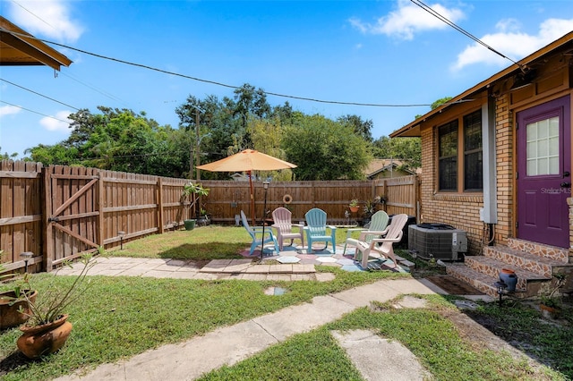 view of yard with a patio and central AC