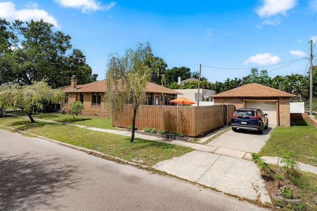 ranch-style home featuring a garage and a front lawn