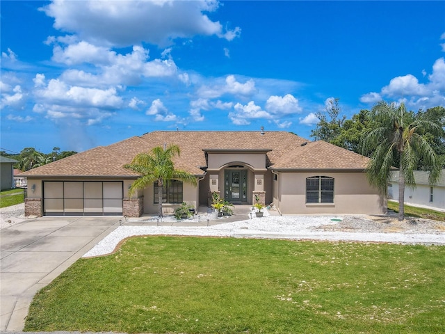 view of front of house with a garage and a front yard