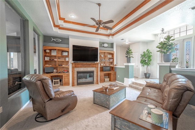 10177 Sunburst Ct, Spring Hill, FL 34608 - living area featuring a fireplace with flush hearth, a raised ceiling, a ceiling fan, and carpet flooring