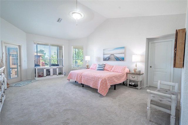 bedroom with vaulted ceiling and light colored carpet