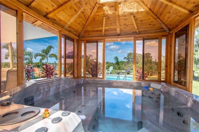 view of swimming pool featuring a hot tub