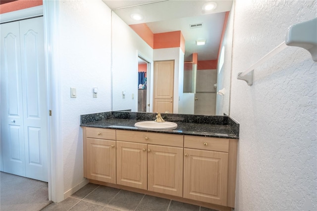 10177 Sunburst Ct, Spring Hill, FL 34608 - full bath featuring a textured wall, visible vents, a shower stall, and vanity