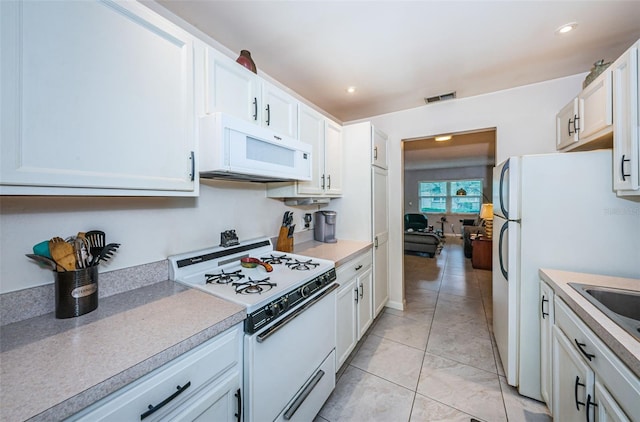 kitchen with white appliances and white cabinets