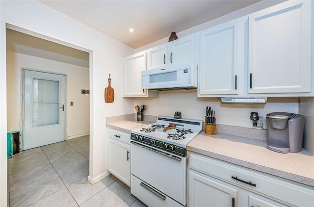 kitchen featuring white cabinetry, white appliances, and light tile patterned floors