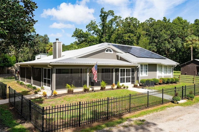 view of front of house featuring a front yard and a sunroom