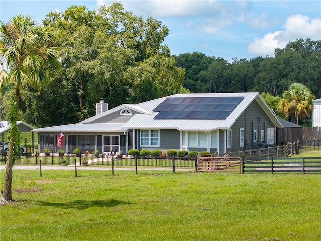 ranch-style house with a front lawn and solar panels