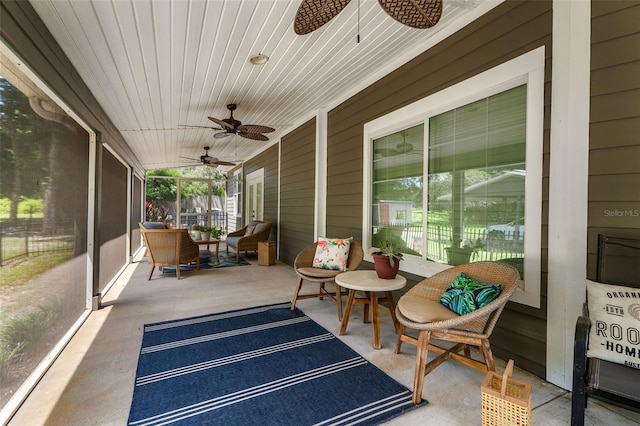 sunroom / solarium with ceiling fan and vaulted ceiling