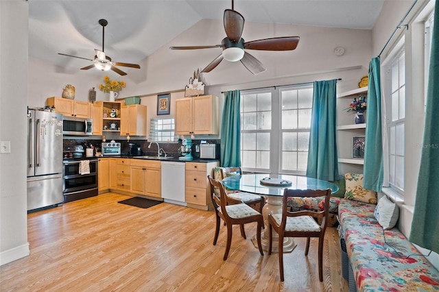 kitchen featuring appliances with stainless steel finishes, lofted ceiling, light brown cabinets, and ceiling fan