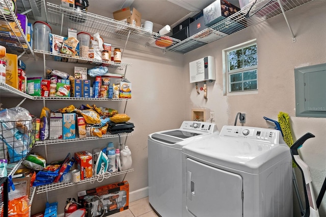 laundry room featuring light tile patterned floors, electric panel, and washing machine and dryer