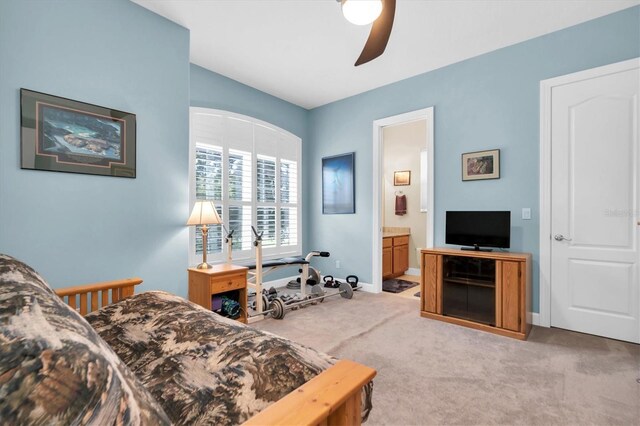 bedroom featuring carpet floors, a ceiling fan, baseboards, and connected bathroom