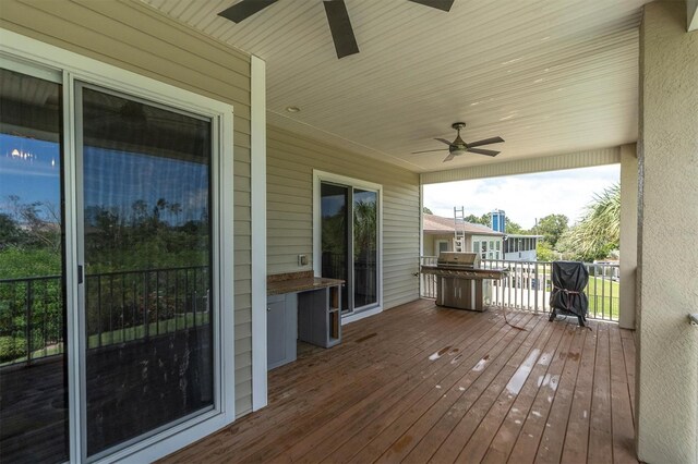 wooden deck featuring ceiling fan and grilling area