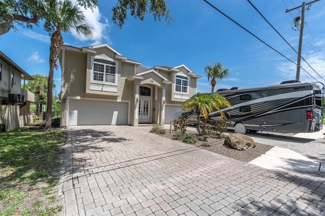 view of front facade featuring decorative driveway and an attached garage