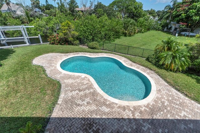 view of pool featuring a fenced backyard, a lawn, a fenced in pool, and a patio