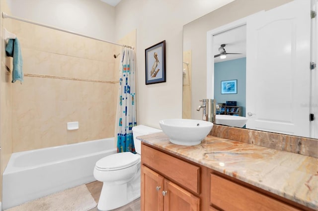 full bath with toilet, ceiling fan, shower / bath combo with shower curtain, and vanity