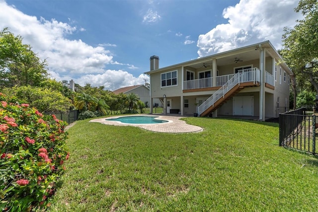 back of house featuring ceiling fan, a fenced backyard, stairway, a yard, and a patio area