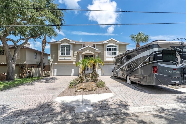 view of front of property with decorative driveway and an attached garage