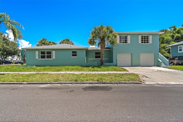 view of front of house with a garage and a front lawn