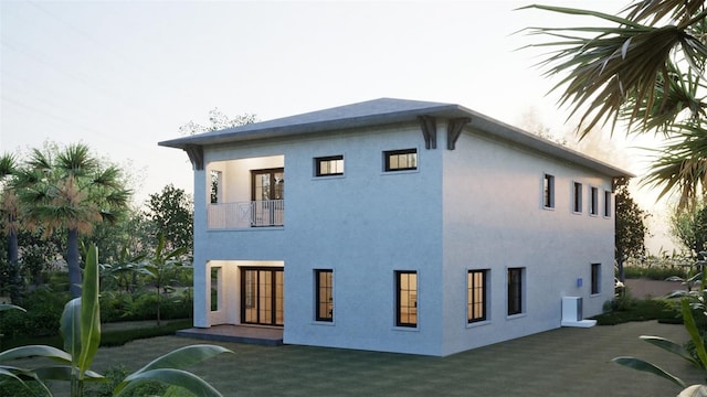 1045 Conant Ave, Safety Harbor, FL 34695 - rear view of house featuring stucco siding, a patio, and a balcony