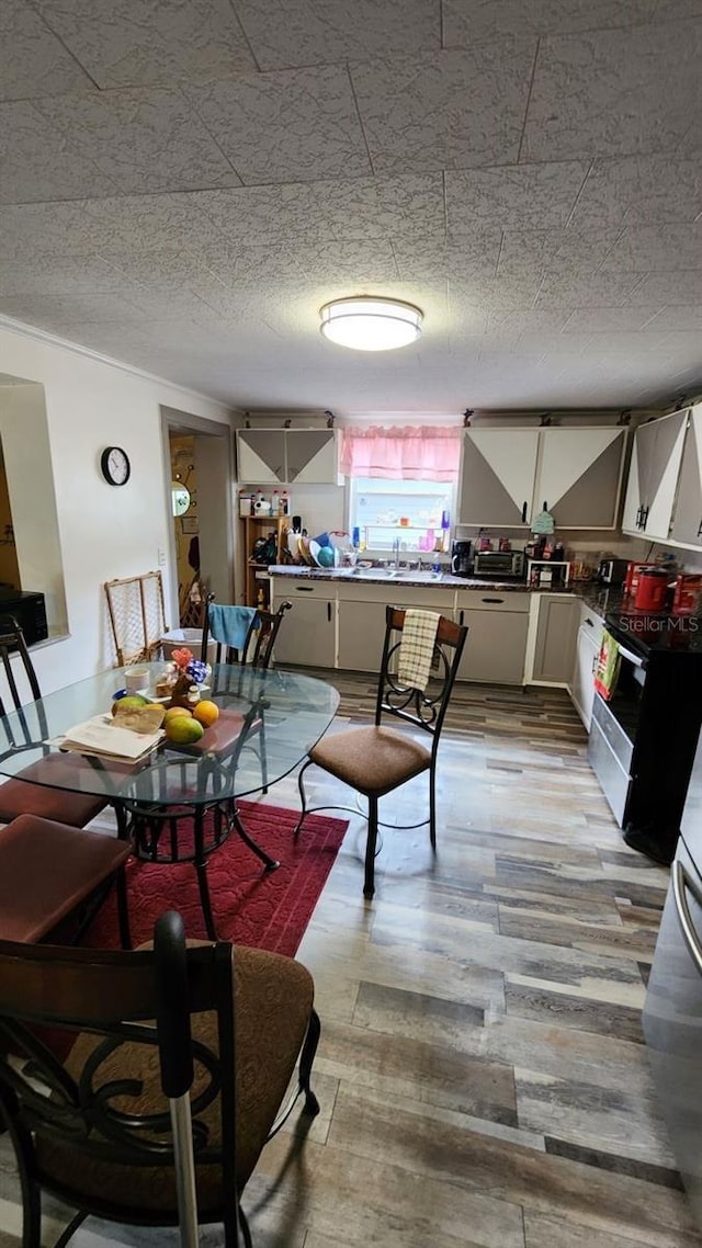 dining space featuring a textured ceiling and light wood-type flooring