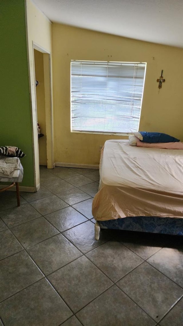 bedroom featuring tile patterned flooring and baseboards