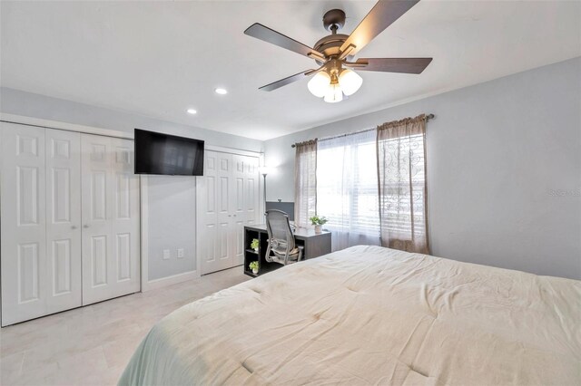 bedroom featuring multiple closets and ceiling fan