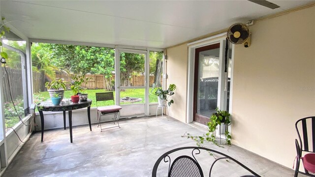 sunroom / solarium featuring ceiling fan