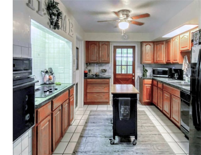 kitchen with black appliances, light tile patterned flooring, backsplash, and ceiling fan