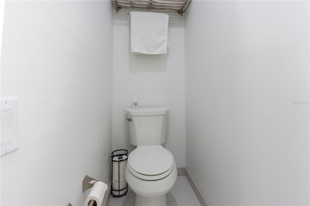 bathroom with toilet and tile patterned floors